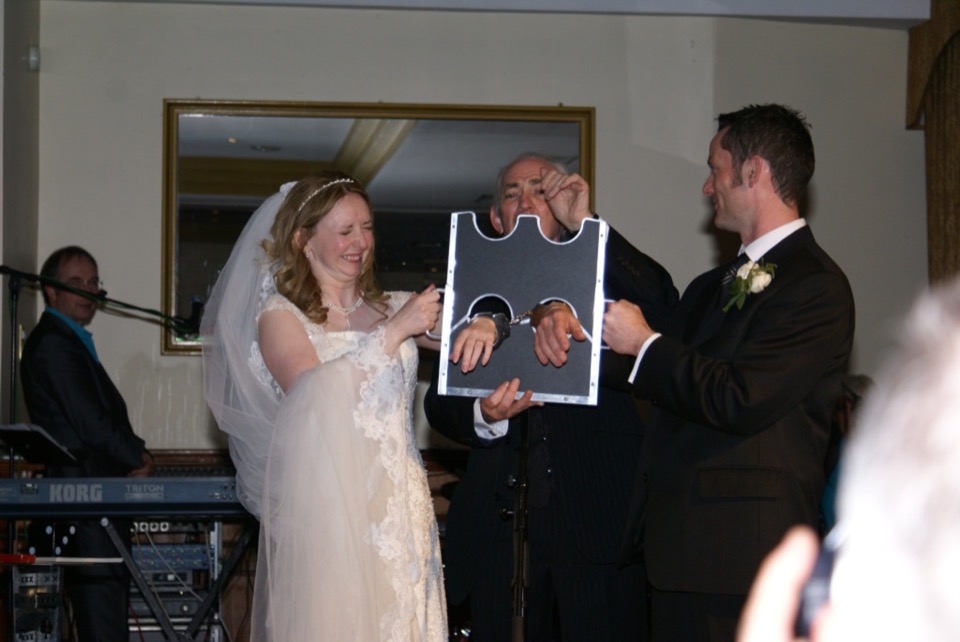 Bride and groom joining in during an evening wedding show moment.